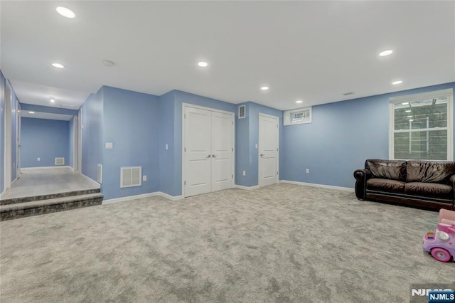 unfurnished living room featuring carpet floors, visible vents, and recessed lighting