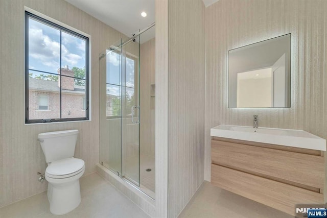 full bathroom featuring a shower stall, vanity, toilet, and tile patterned floors