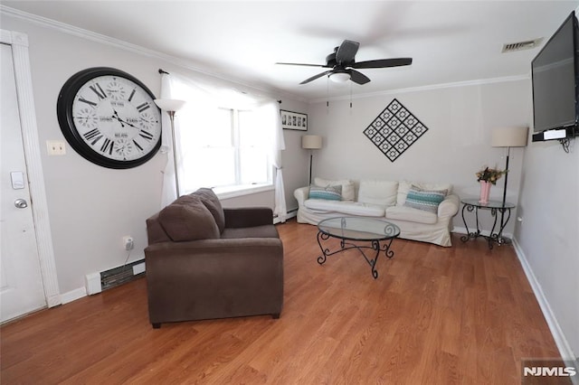 living area with ornamental molding, a baseboard radiator, wood finished floors, and visible vents