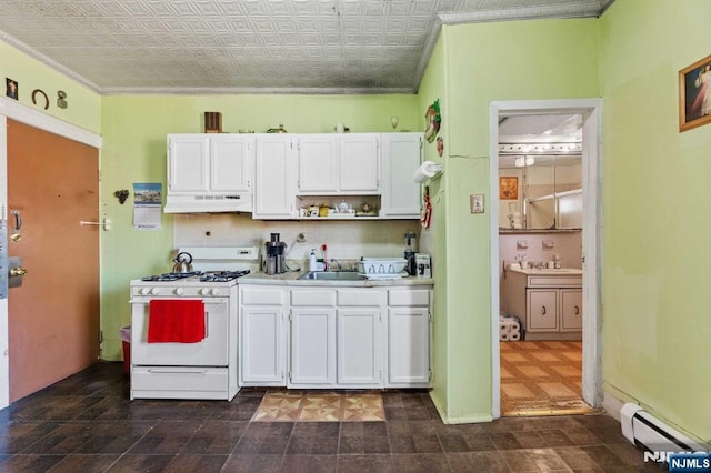 kitchen featuring white gas stove, under cabinet range hood, a baseboard heating unit, a sink, and white cabinets