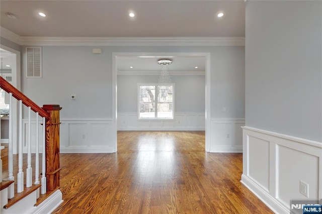 entryway with recessed lighting, wood finished floors, visible vents, and stairs