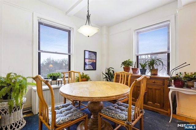 dining area with beam ceiling