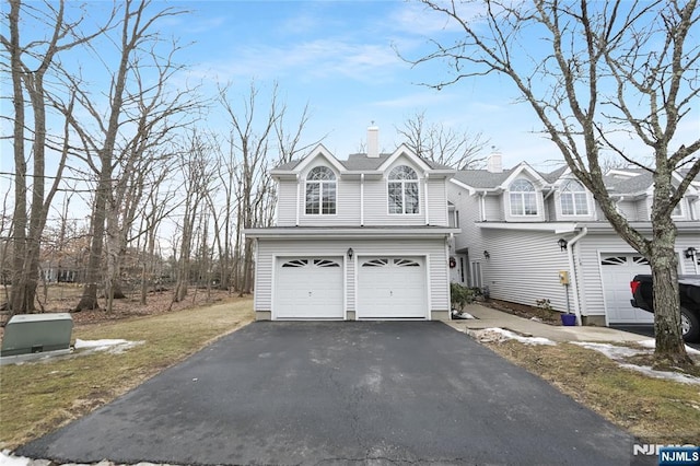 view of front of home featuring a garage and aphalt driveway