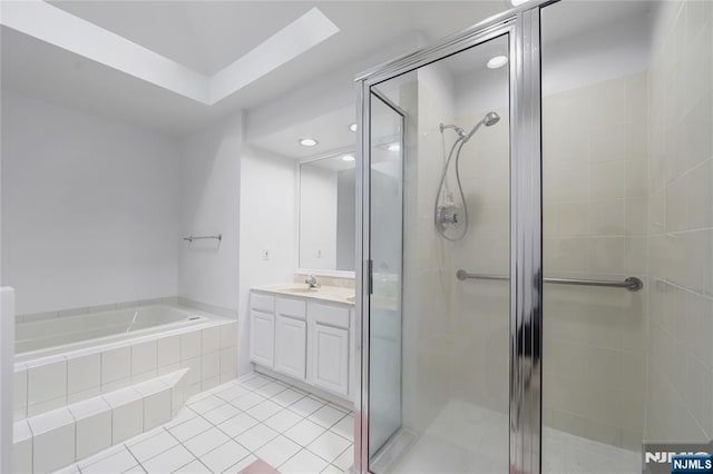 bathroom featuring a stall shower, tile patterned floors, a bath, and vanity