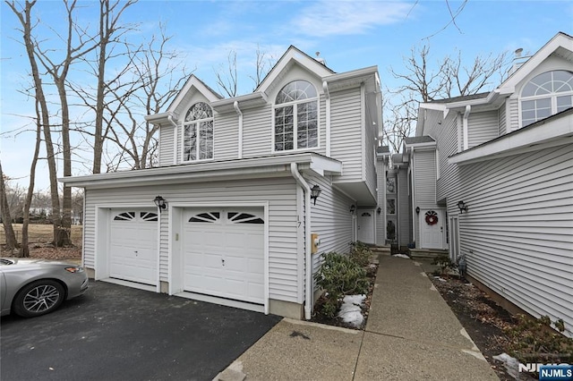 view of side of property featuring a garage and driveway