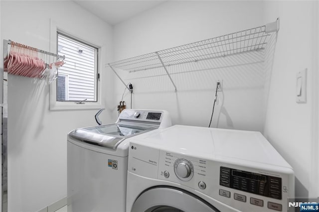 clothes washing area with laundry area and separate washer and dryer