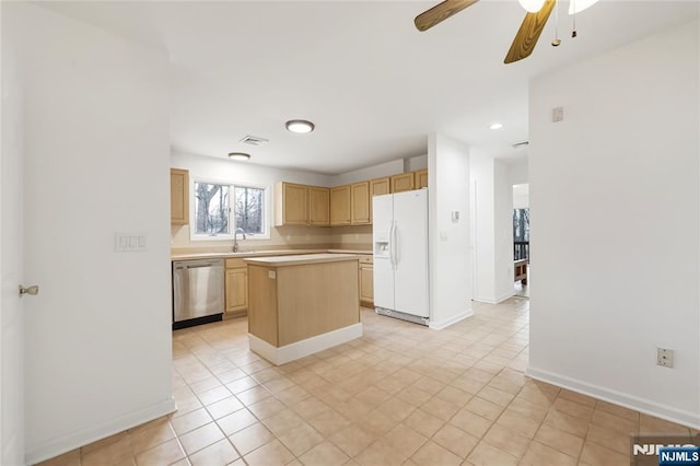 kitchen with light brown cabinets, light countertops, a center island, dishwasher, and white fridge with ice dispenser