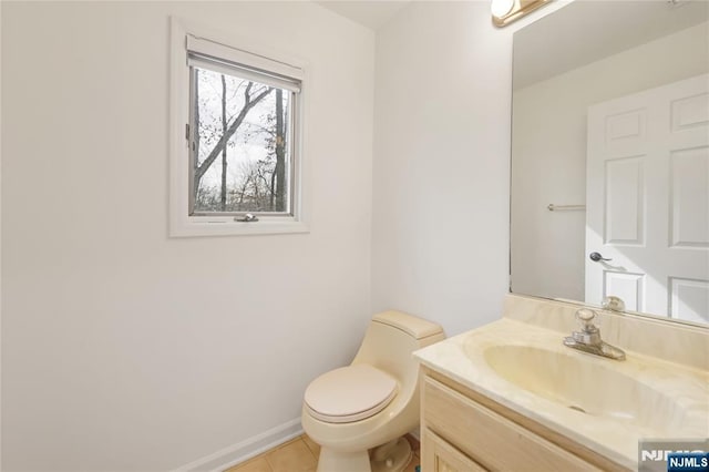 bathroom featuring tile patterned flooring, vanity, toilet, and baseboards