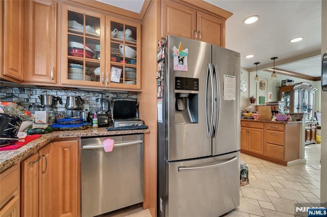 kitchen with stainless steel appliances, stone countertops, glass insert cabinets, and tasteful backsplash