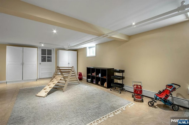 recreation room with baseboards and tile patterned flooring