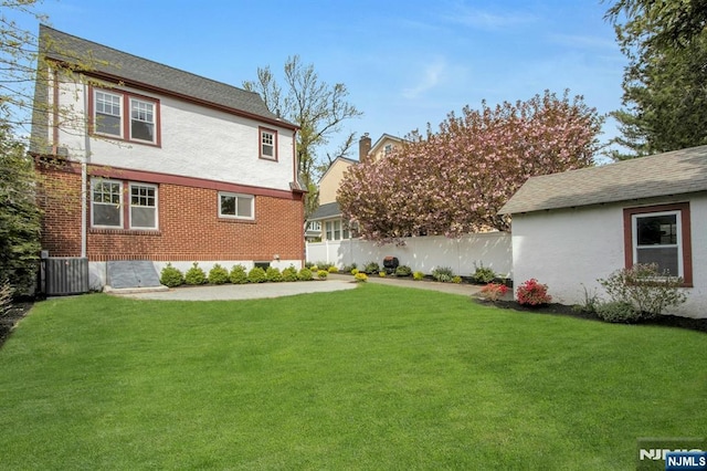 view of yard featuring fence and cooling unit