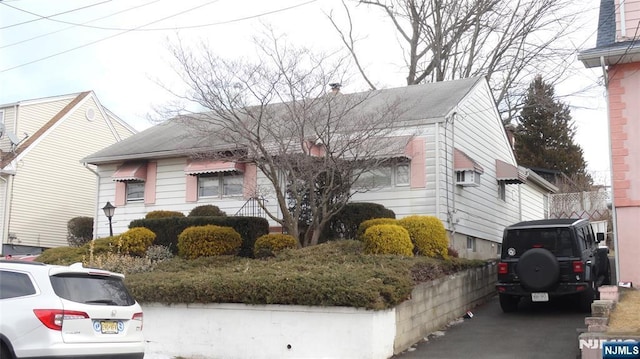 view of front of home featuring a chimney