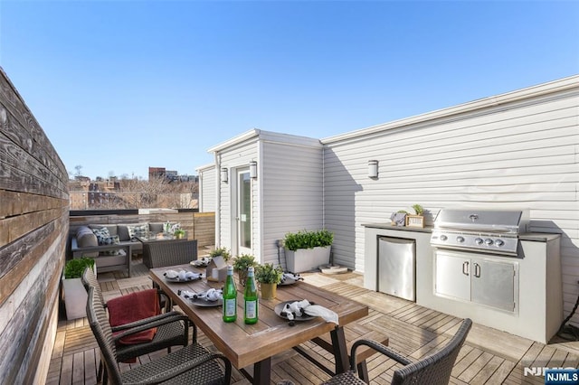 wooden terrace featuring an outdoor living space, outdoor dining area, grilling area, and an outdoor kitchen