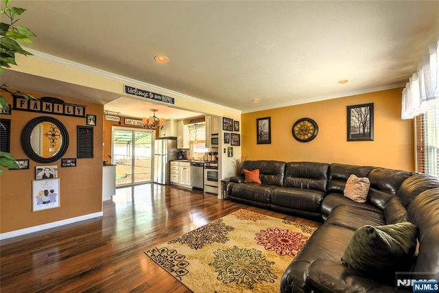 living area with ornamental molding, dark wood-style flooring, and baseboards