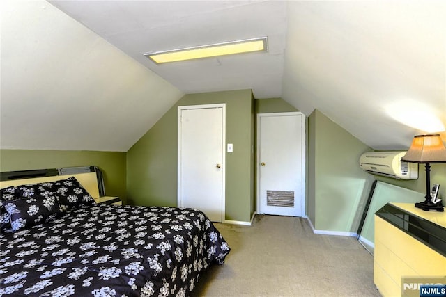 bedroom with light carpet, vaulted ceiling, a wall unit AC, and baseboards