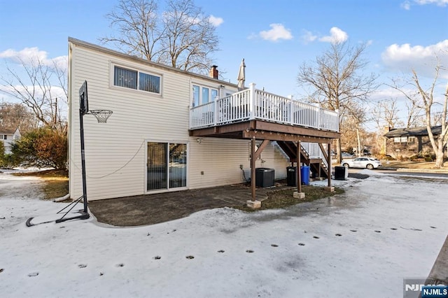 back of property featuring stairway, a wooden deck, and central air condition unit