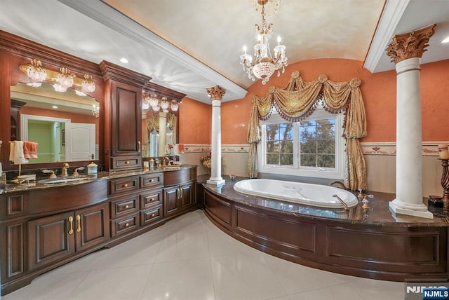 full bathroom with vaulted ceiling, wainscoting, a sink, and ornate columns