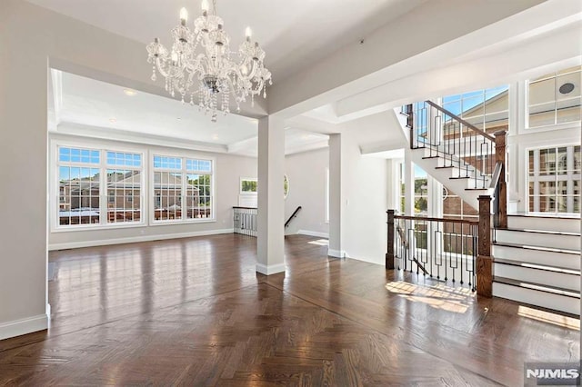 unfurnished living room featuring recessed lighting, baseboards, and an inviting chandelier