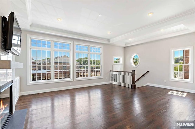 unfurnished living room featuring crown molding, a fireplace, visible vents, dark wood-type flooring, and baseboards