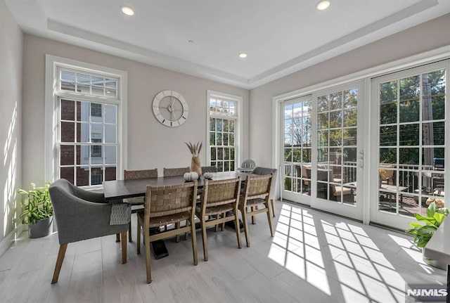 dining space featuring recessed lighting and a raised ceiling