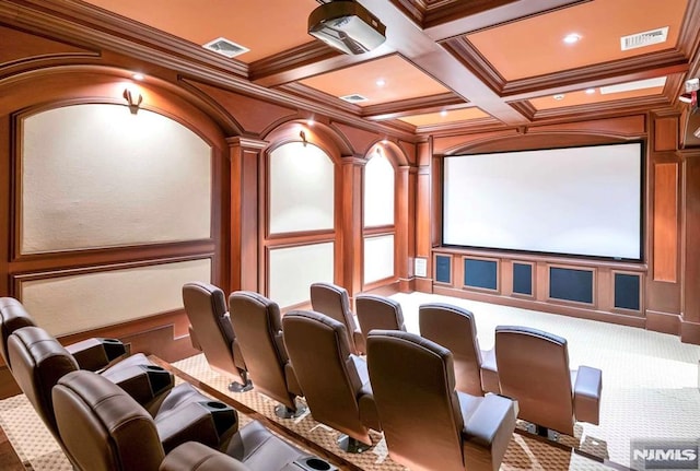 carpeted home theater featuring beam ceiling, crown molding, visible vents, a decorative wall, and coffered ceiling