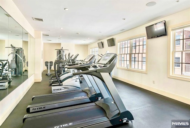 exercise room with recessed lighting, visible vents, and baseboards