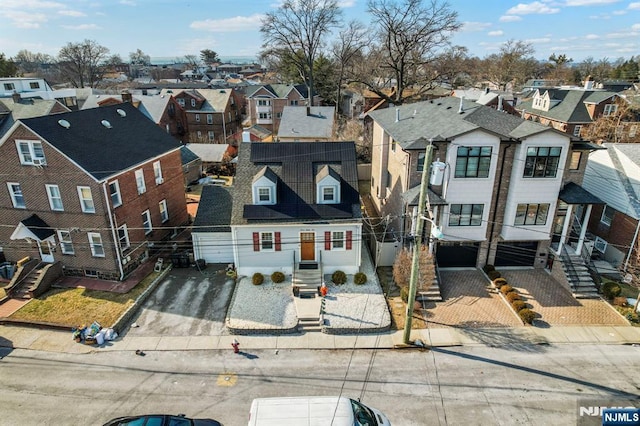 birds eye view of property with a residential view