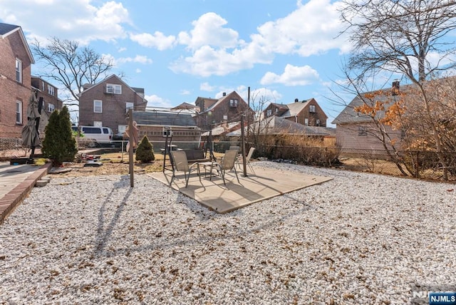 view of yard with a residential view, fence, and a patio