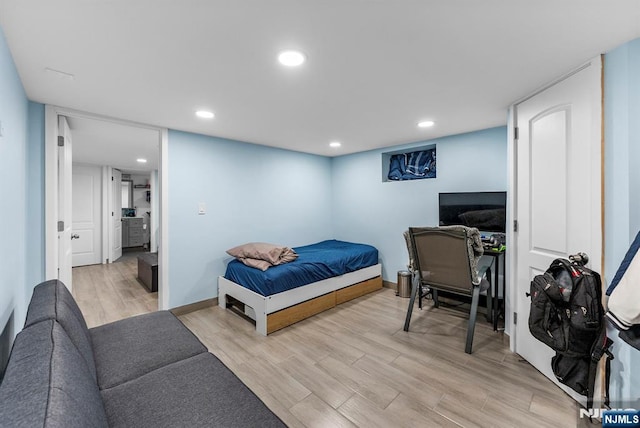 bedroom with recessed lighting, baseboards, and light wood finished floors