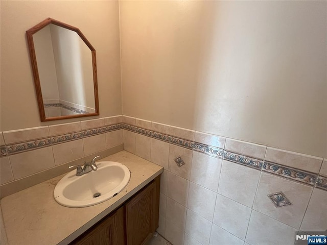 bathroom with tile walls and vanity