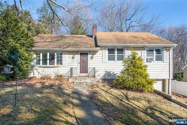 single story home with entry steps, a garage, a chimney, and fence