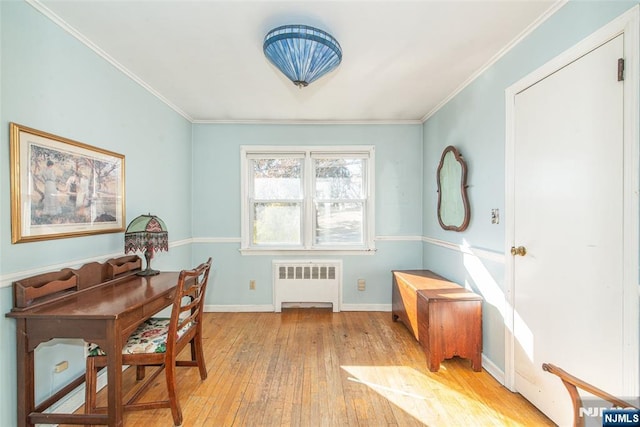 office with baseboards, crown molding, radiator heating unit, and hardwood / wood-style flooring