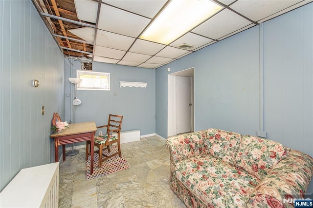 living room with a paneled ceiling and visible vents