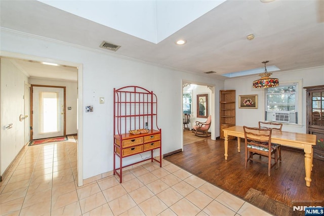 dining space featuring light tile patterned floors, visible vents, and ornamental molding