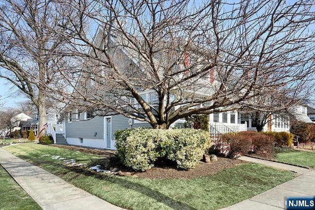 view of side of home with a yard