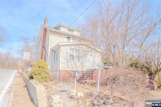 view of front of home featuring a chimney