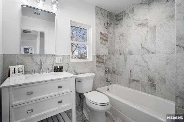 bathroom with  shower combination, visible vents, vanity, and toilet