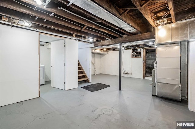 finished basement featuring washer / clothes dryer and stairway