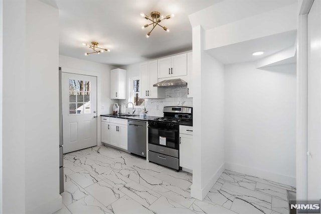 kitchen with marble finish floor, stainless steel dishwasher, a sink, gas range, and under cabinet range hood