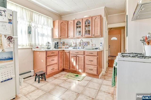 kitchen with extractor fan, white appliances, a sink, light countertops, and baseboard heating