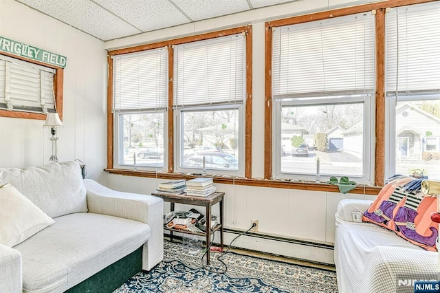 interior space featuring a drop ceiling and baseboard heating