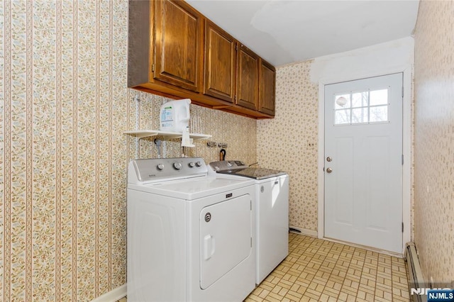 laundry room featuring cabinet space, a baseboard heating unit, wallpapered walls, and washing machine and clothes dryer