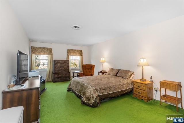 carpeted bedroom featuring visible vents