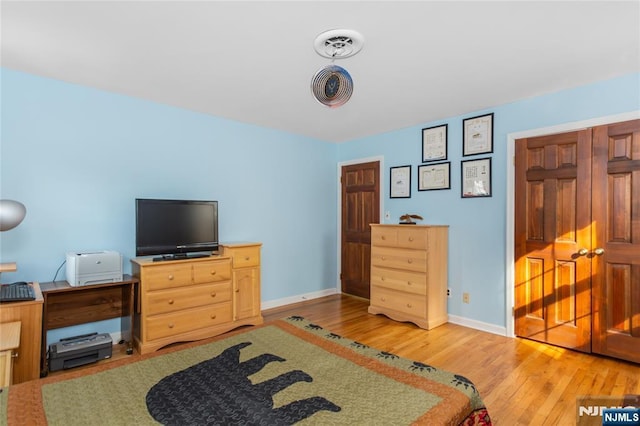 bedroom featuring baseboards and wood finished floors