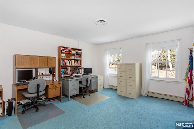 office featuring plenty of natural light, a baseboard radiator, visible vents, and light colored carpet