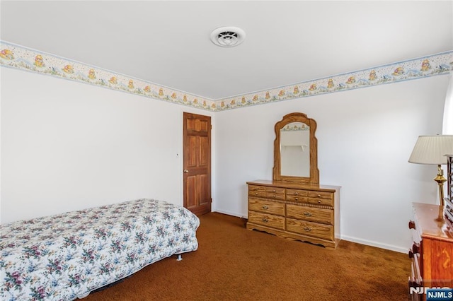 bedroom featuring visible vents, dark carpet, and baseboards