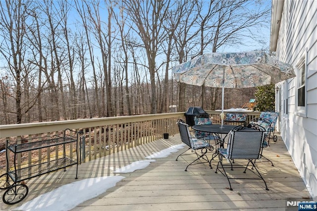 wooden deck with outdoor dining space