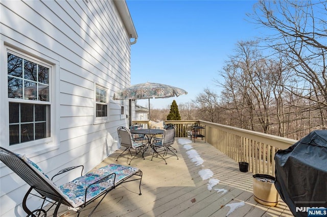 deck featuring outdoor dining space and area for grilling