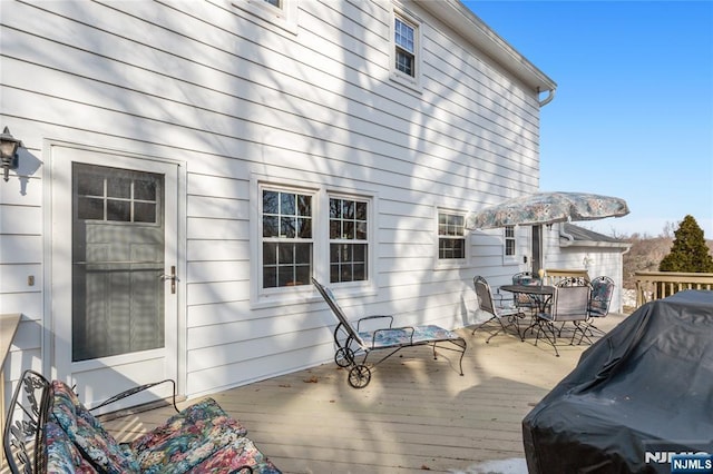 wooden deck featuring outdoor dining space