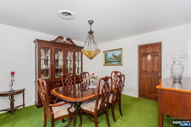 carpeted dining room featuring baseboards and visible vents